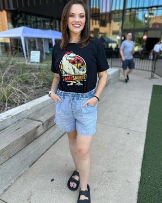 posing with hands in her pockets